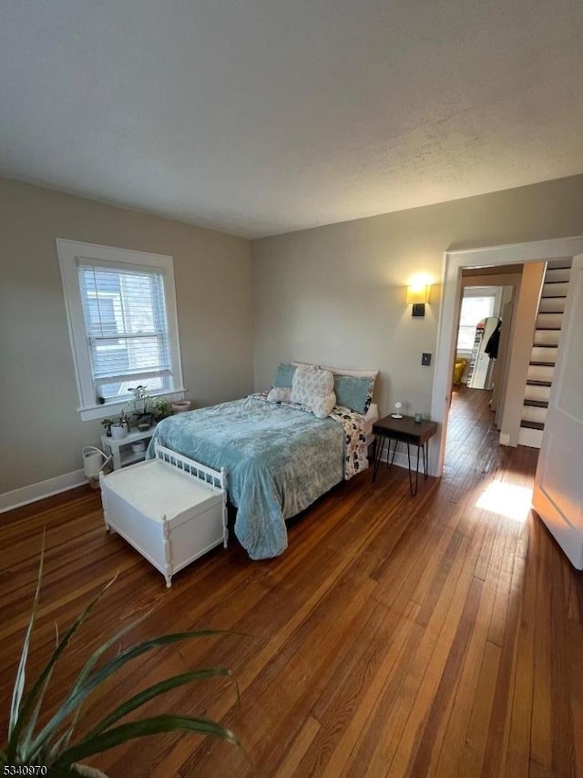 bedroom featuring hardwood / wood-style flooring and baseboards