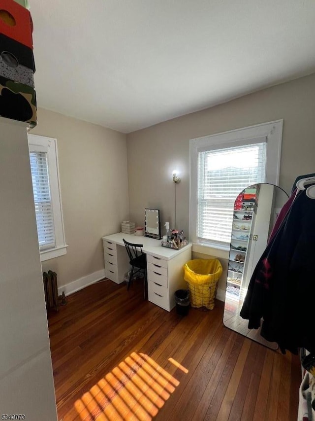 office space featuring radiator, baseboards, and hardwood / wood-style floors