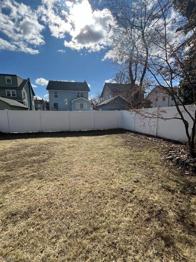 view of yard with a fenced backyard