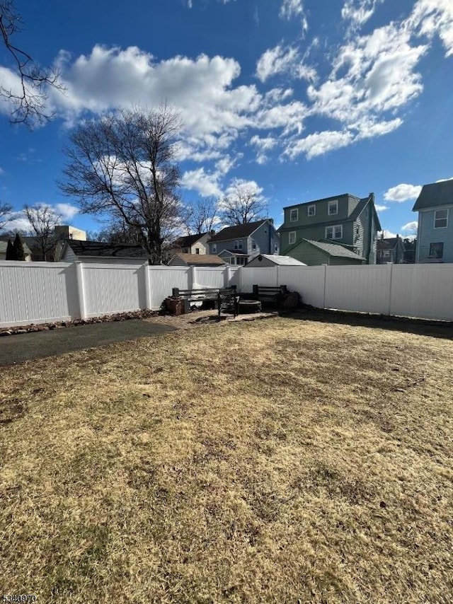 view of yard with a fenced backyard and a residential view