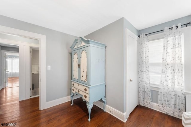 interior space featuring baseboards and wood finished floors