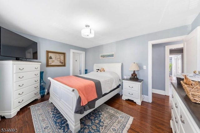 bedroom with dark wood-style floors and baseboards