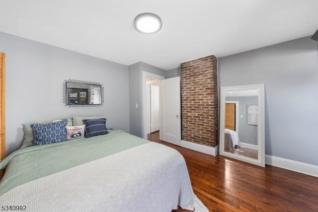 bedroom featuring baseboards and wood finished floors