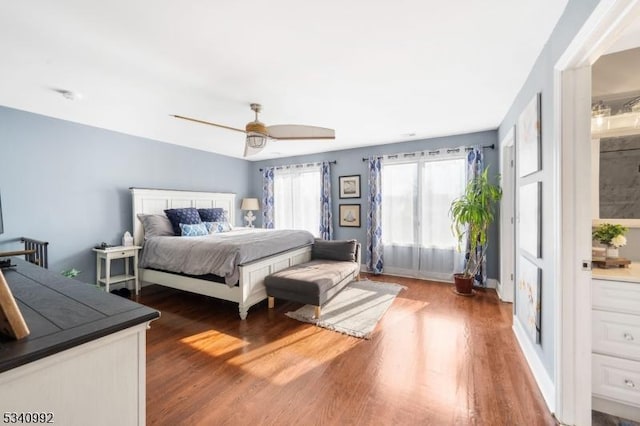 bedroom featuring baseboards, a ceiling fan, and wood finished floors