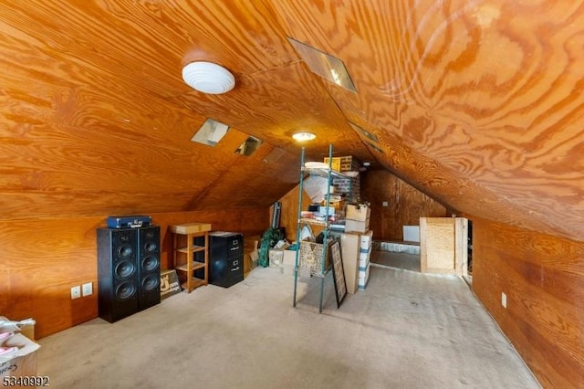 additional living space with wooden walls and vaulted ceiling