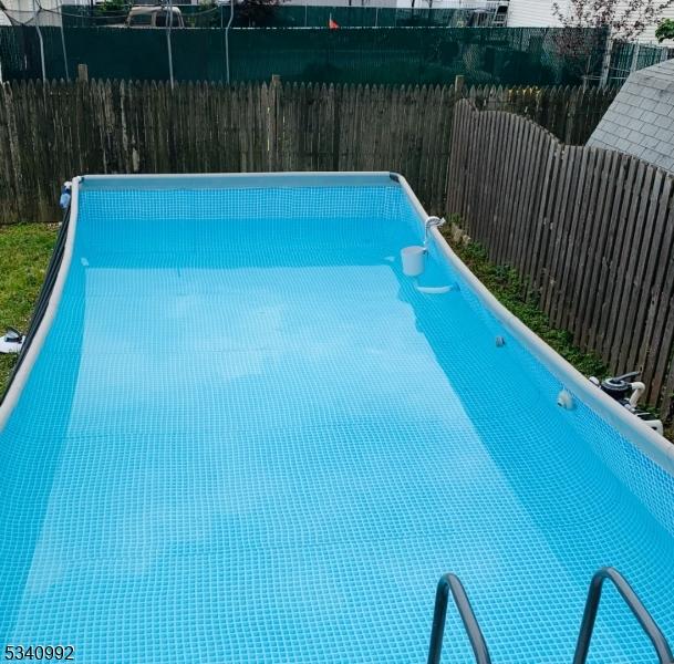 view of pool with a fenced backyard