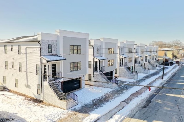 view of front of house featuring a residential view and stucco siding