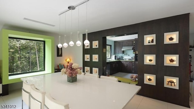 dining area featuring rail lighting, visible vents, and light tile patterned floors