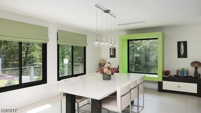 dining area featuring light tile patterned flooring and a wealth of natural light