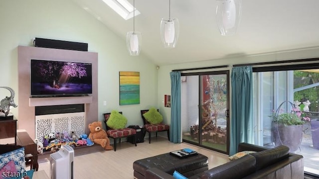 interior space featuring high vaulted ceiling, a skylight, and wood finished floors