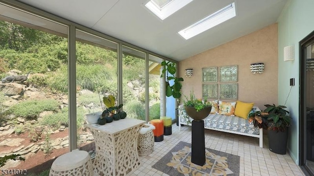 sunroom / solarium featuring vaulted ceiling with skylight