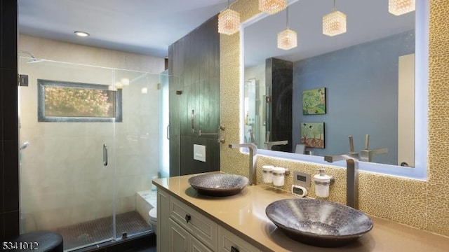 full bathroom with a shower stall and vanity