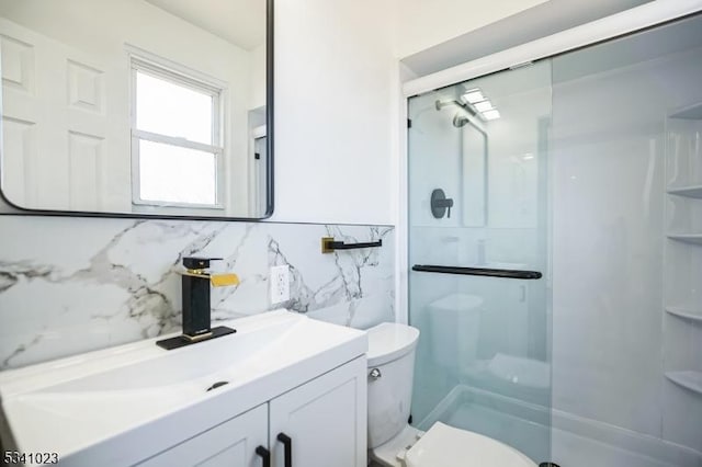 full bath with vanity, toilet, and a shower stall