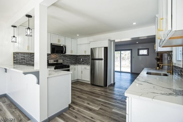 kitchen featuring white cabinetry, dark wood-style flooring, appliances with stainless steel finishes, and a sink