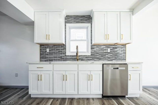 kitchen with dishwasher, light countertops, white cabinetry, and a sink