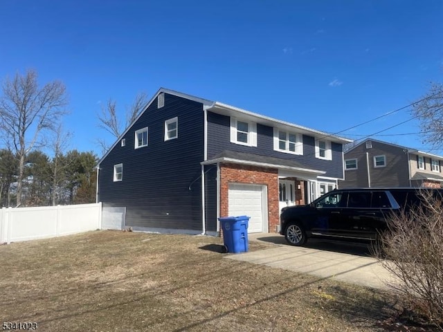 view of side of property with brick siding, concrete driveway, an attached garage, and fence