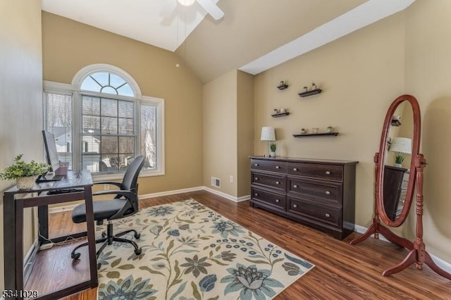 office featuring dark wood-style floors, lofted ceiling, baseboards, and a ceiling fan