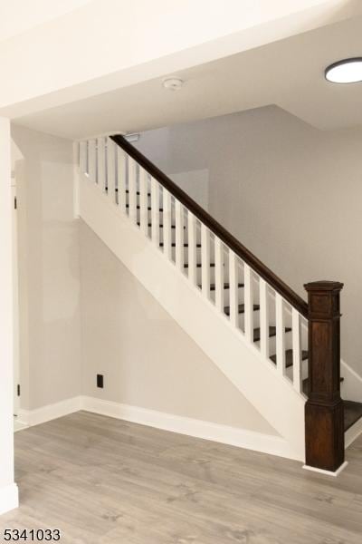 stairs featuring baseboards and wood finished floors