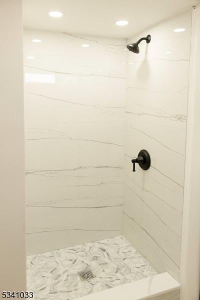 bathroom with a shower stall and recessed lighting