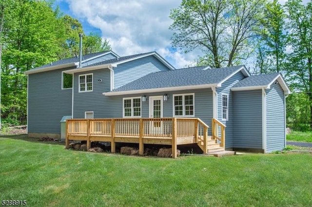 back of property with a lawn and a deck