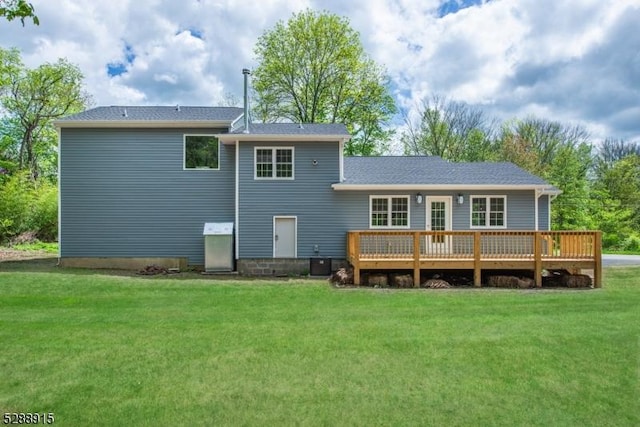 rear view of house featuring a yard and a wooden deck