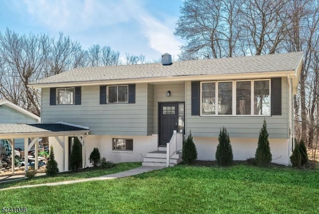 raised ranch with a front yard and a shingled roof