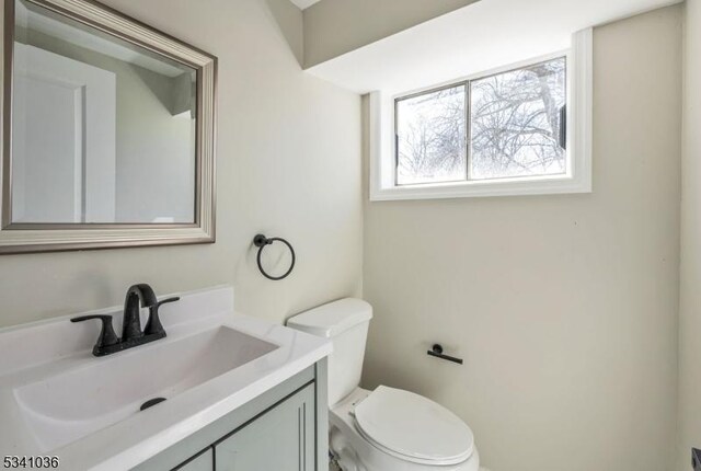 bathroom featuring toilet and vanity