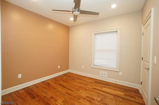 unfurnished bedroom with recessed lighting, wood finished floors, a ceiling fan, visible vents, and baseboards