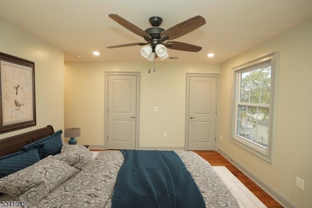 bedroom with recessed lighting, baseboards, and wood finished floors