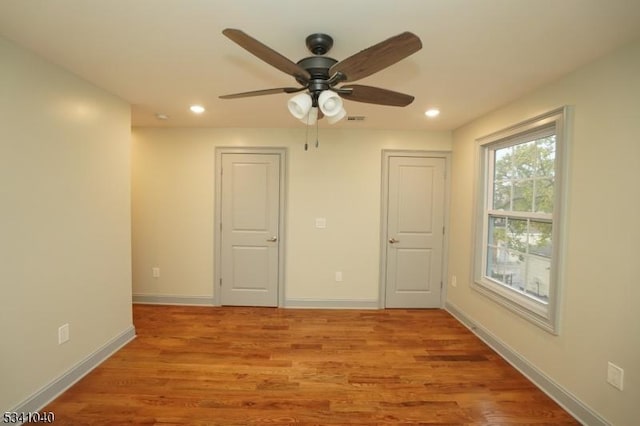 spare room with visible vents, recessed lighting, light wood-style flooring, and baseboards