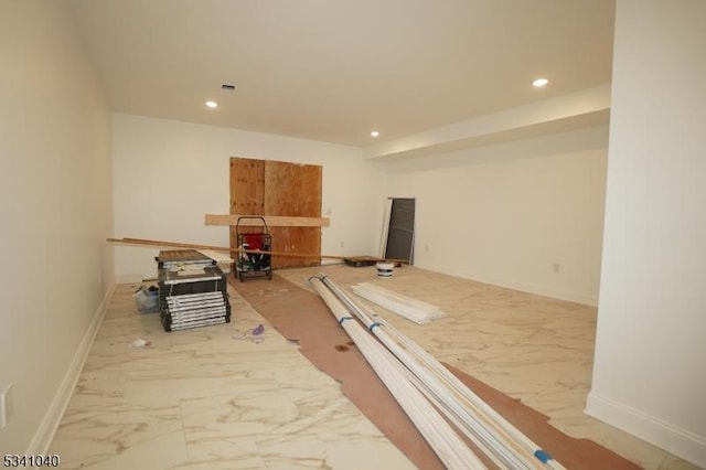 interior space with marble finish floor, baseboards, and recessed lighting