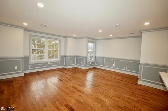 spare room featuring ornamental molding, wood finished floors, and recessed lighting