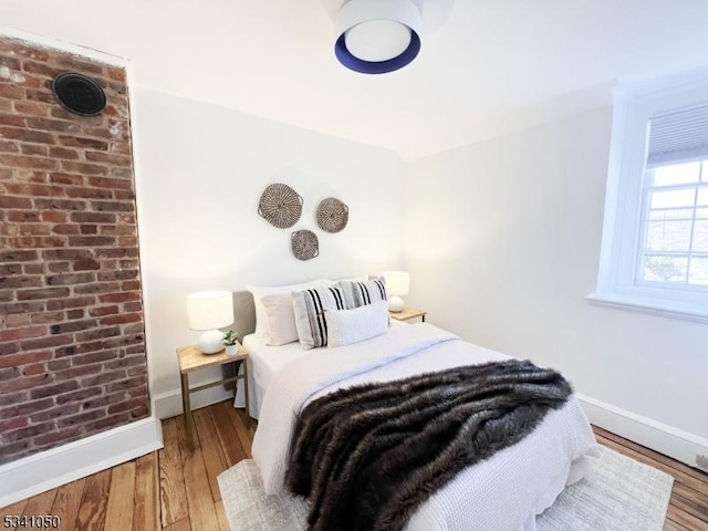 bedroom featuring baseboards and wood-type flooring