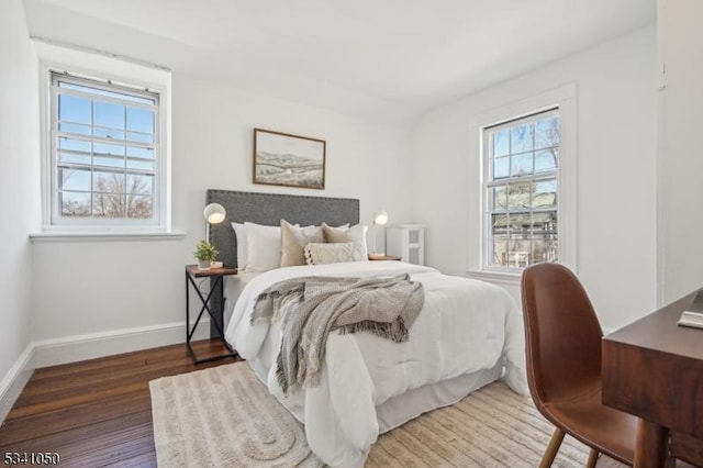 bedroom with wood finished floors and baseboards