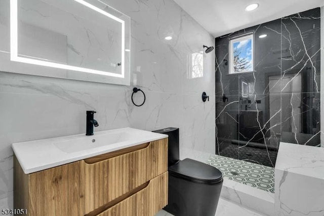 full bath with a marble finish shower, toilet, marble finish floor, vanity, and tile walls