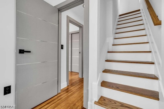 stairway with wood finished floors