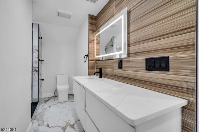 bathroom with marble finish floor, visible vents, toilet, vanity, and baseboards