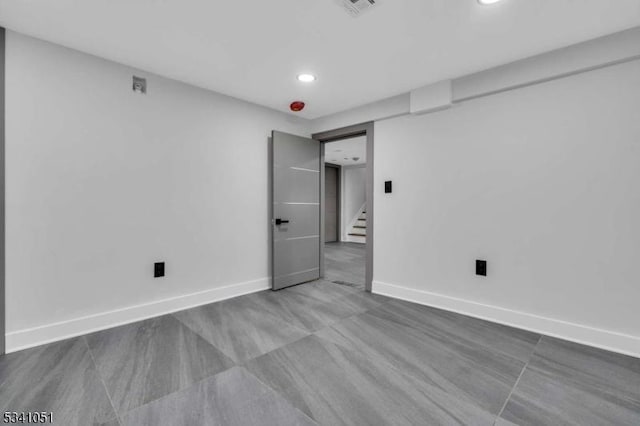 spare room with recessed lighting, visible vents, baseboards, and stairs