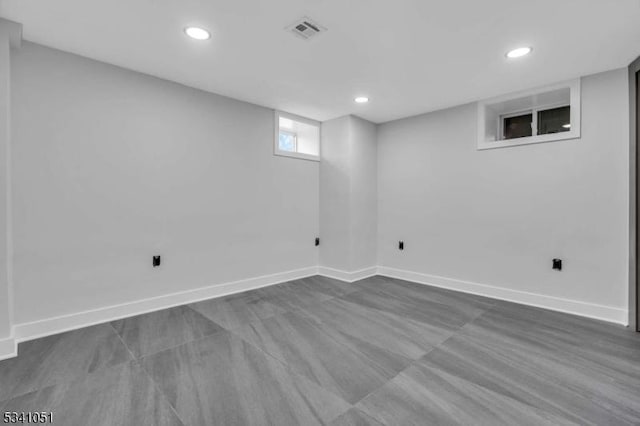 basement with recessed lighting, visible vents, and baseboards