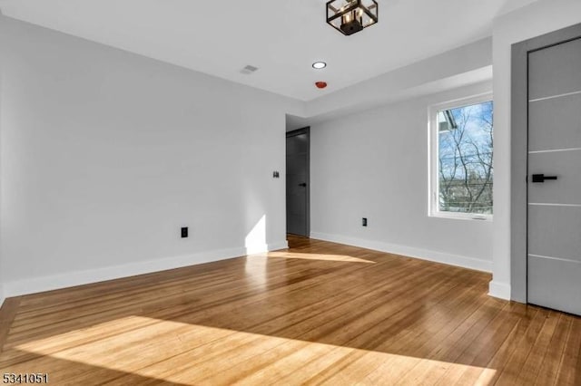 interior space featuring recessed lighting, visible vents, baseboards, and wood finished floors