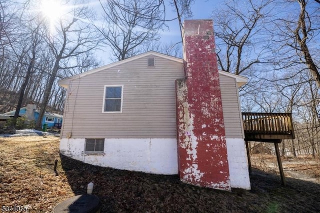 view of side of property with a wooden deck