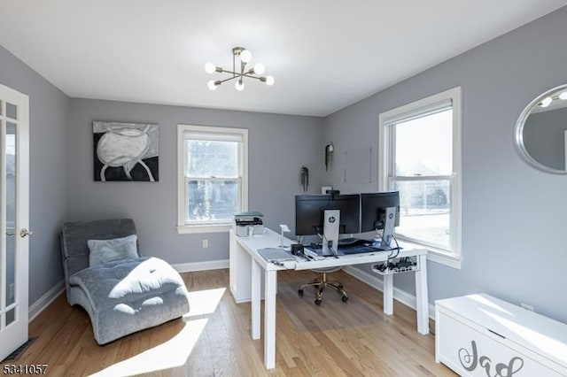 office with a chandelier, light wood-style flooring, and baseboards