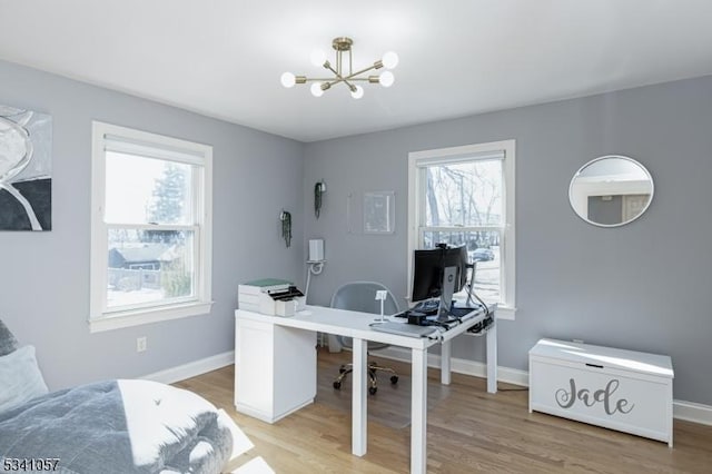 office with an inviting chandelier, light wood-style flooring, baseboards, and a wealth of natural light