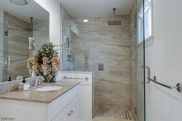 bathroom with a stall shower and vanity