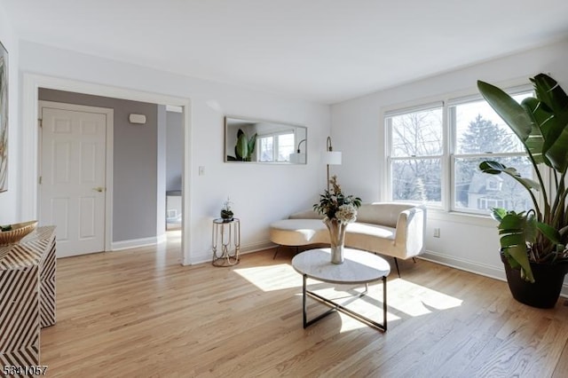 living area with light wood-style floors and baseboards