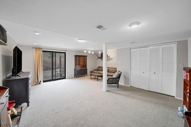 sitting room with carpet, visible vents, and baseboards