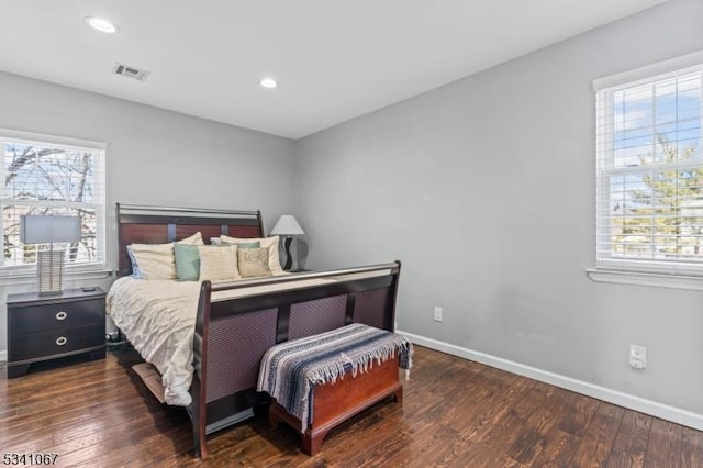 bedroom featuring visible vents, baseboards, wood finished floors, and recessed lighting