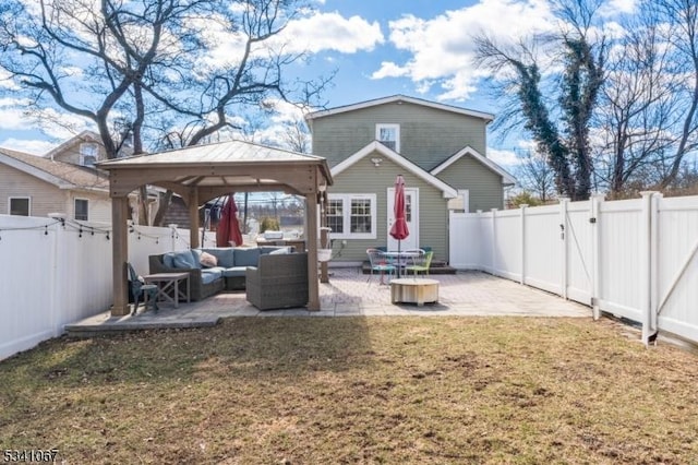 rear view of property featuring a lawn, a patio, a fenced backyard, a gazebo, and an outdoor living space