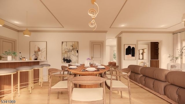 dining room with light wood-style flooring and crown molding