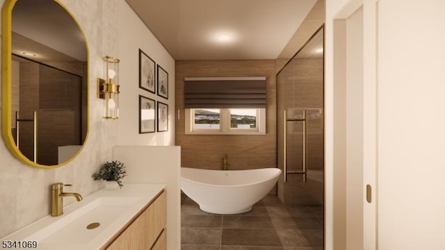 bathroom featuring a soaking tub, tile patterned floors, vanity, and tile walls